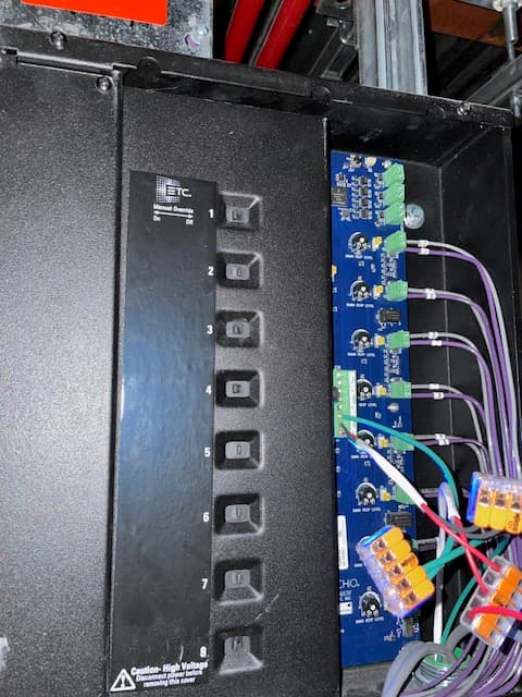 Open ETC electrical panel showing a blue circuit board, wiring, and eight numbered switches.
